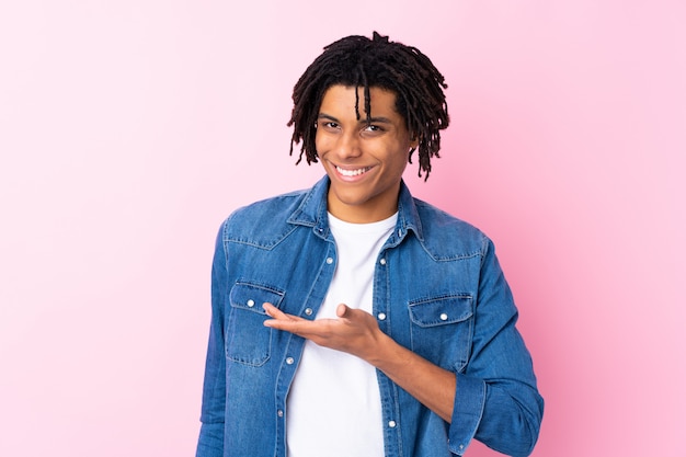 Young man over isolated pink wall