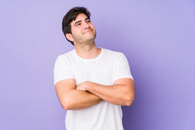 Young man isolated on purple