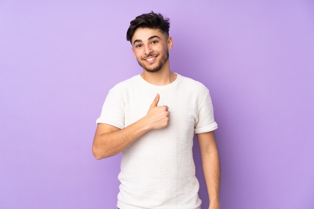 Young man isolated on purple