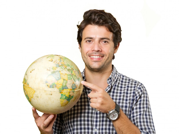 Young man isolated showing a globe