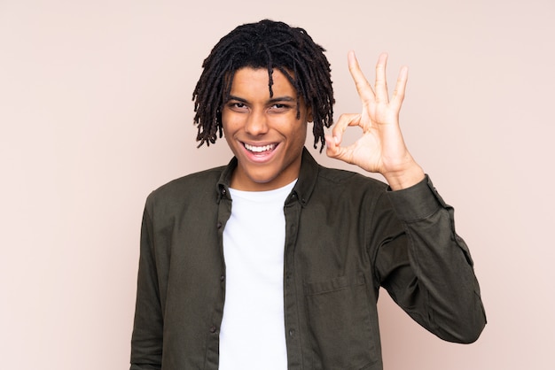 Young man over isolated wall