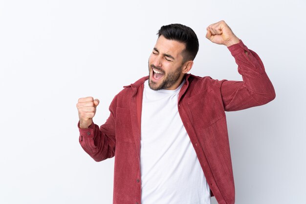 Young man over isolated white wall