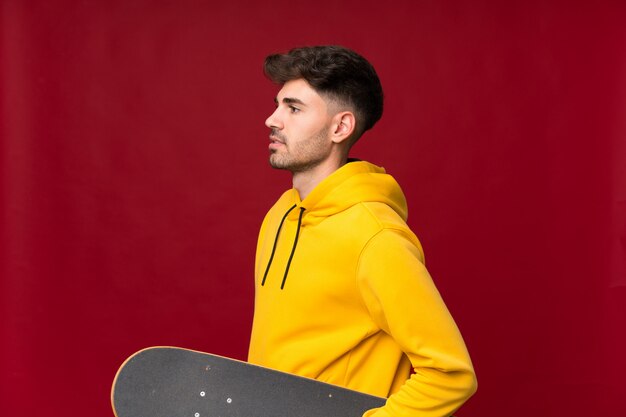 Young man over isolated with skate