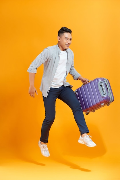 Young man isolated over a yellow color background