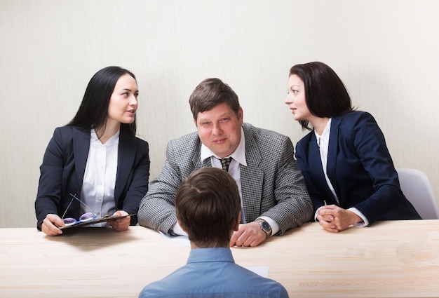 Young man during job interview and members of managemen