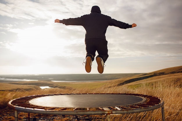 Young man jumping on a trampoline