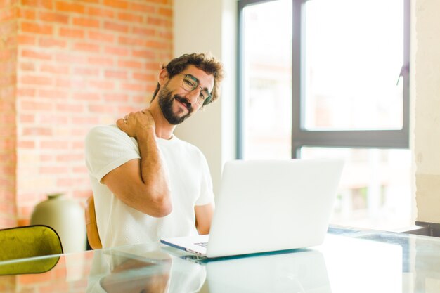 Young man laughing cheerfully and confidently with a casual, happy, friendly smile