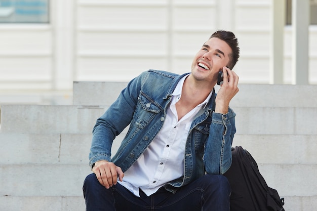 Young man laughing and talking on mobile phone