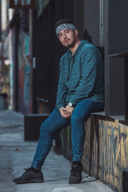 Young man leaning on the wall