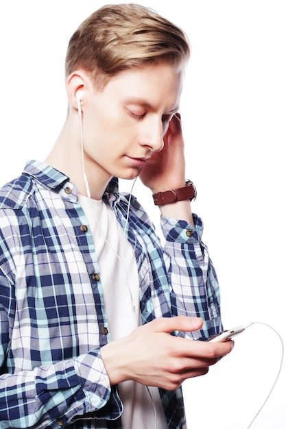 Young man listening to music isolated on white