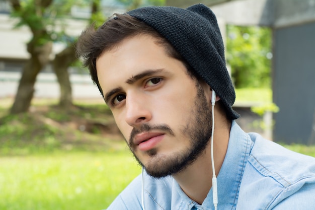 Young man listening to music with earphones