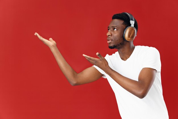 Young man looking away against red background