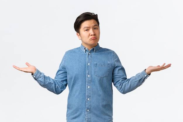 Young man looking away against white background