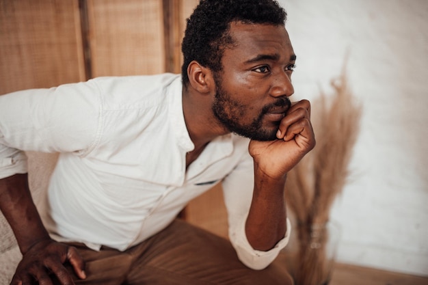 Photo young man looking away while sitting at home