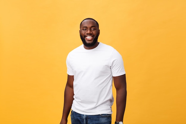 young man looking away while standing against yellow background