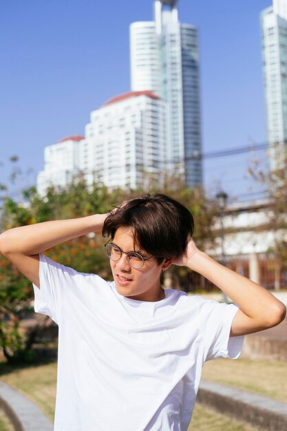 Young man looking away while standing at park