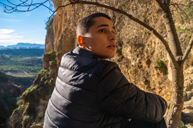 Young man looking at famous Ronda bridge in Spain