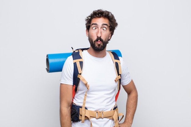 Young man looking goofy and funny with a silly cross-eyed expression, joking and fooling around