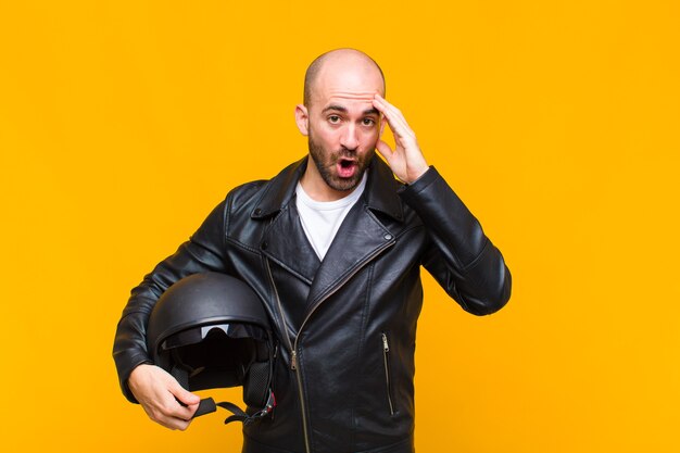 Young man looking happy, astonished and surprised