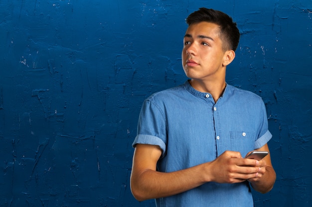 Young man looking on his smartphone