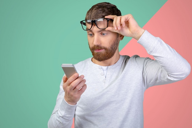 Young man looking at his smartphone