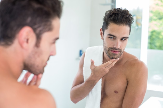 Young man looking in mirror 