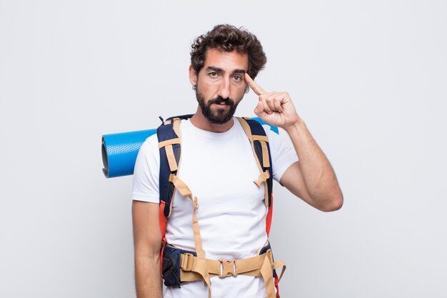 Young man looking surprised, open-mouthed, shocked, realizing a new thought, idea or concept