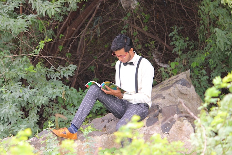 फोटो जमीन पर बैठे हुए युवा व्यक्ति का दृश्य