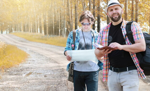 A young man looks at a map autumn season