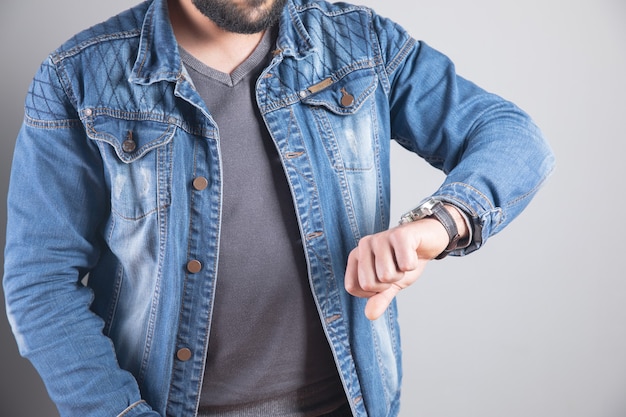 Young man looks at wrist watch