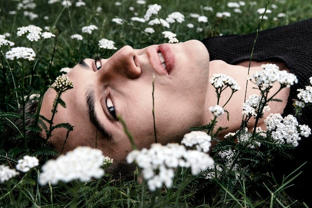 young man lying down on grass