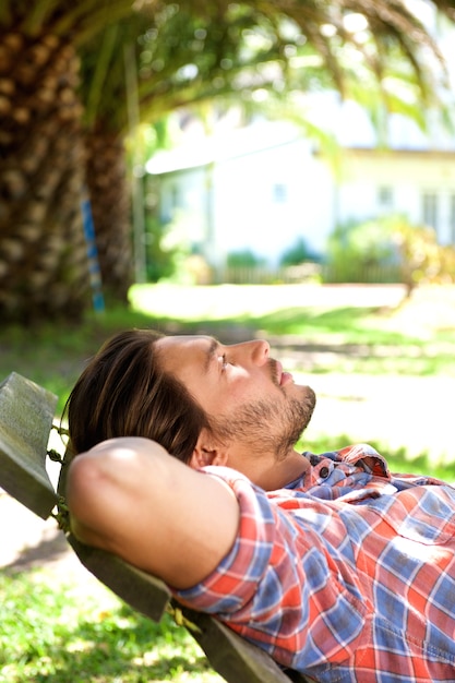 Young man lying in hammock resting