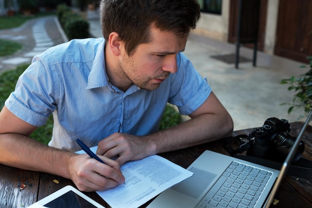 A young man makes a business plan for his personal business