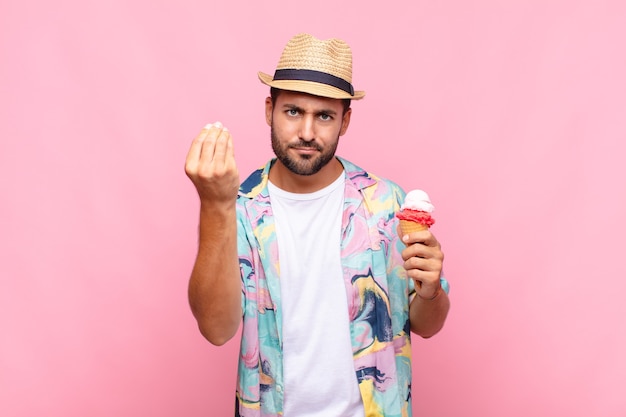 Young man making capice or money gesture