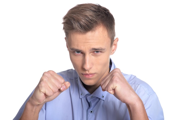 Young man making facial expression against white background