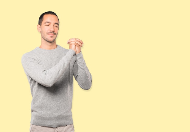 Young man making a gesture of team work with his hands