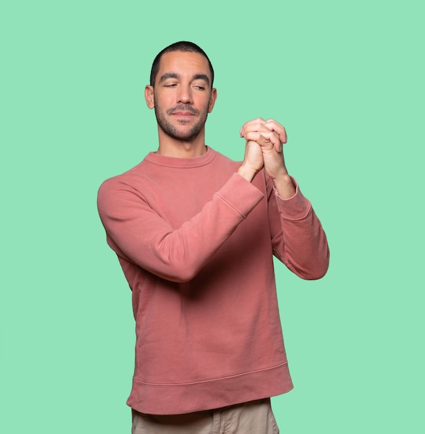 Young man making a gesture of team work with his hands