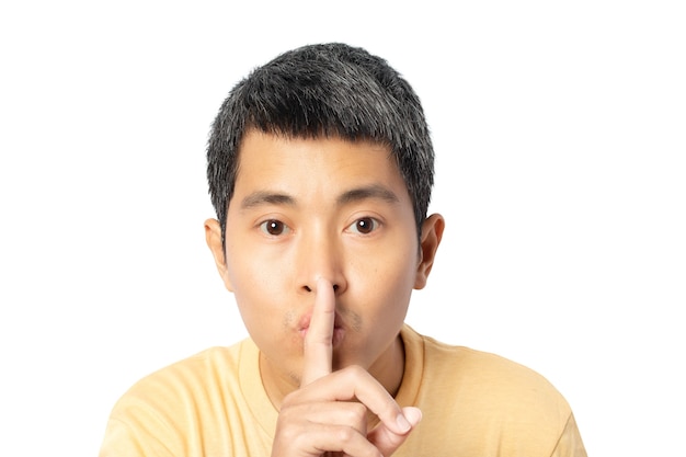 Young man making hush gesture and keep conspiracy isolated on white background. clipping paths. Silence and secret concept.