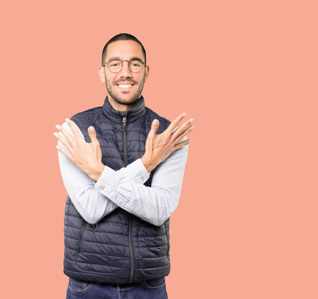 Young man making a number ten gesture