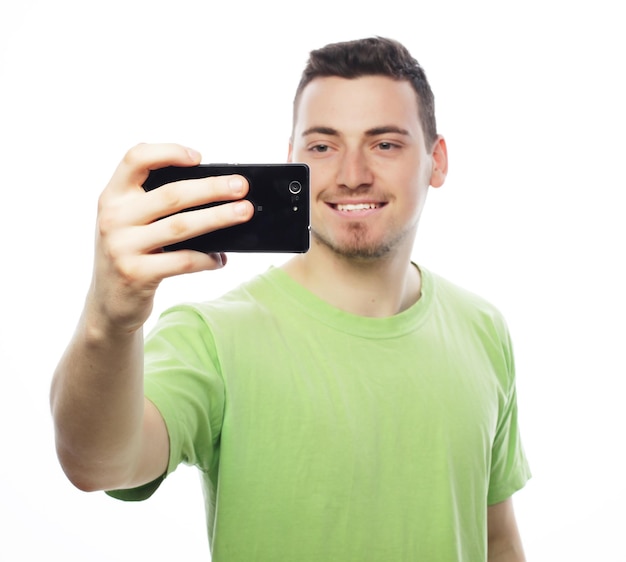 Young man making photo of himself