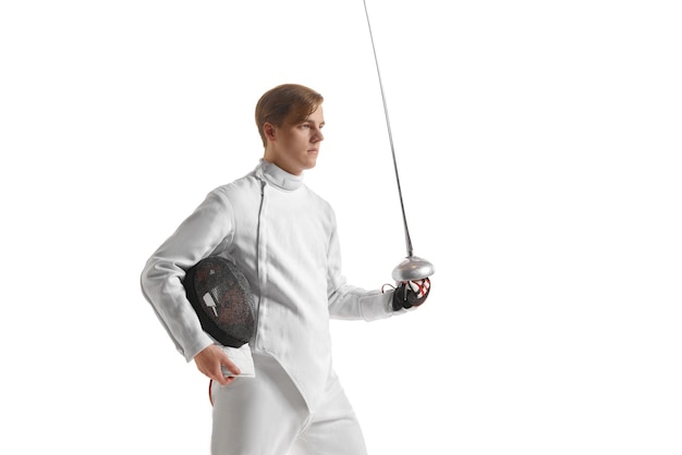 Young man male fencer in fencing costume mask standing with sword over white studio background sport