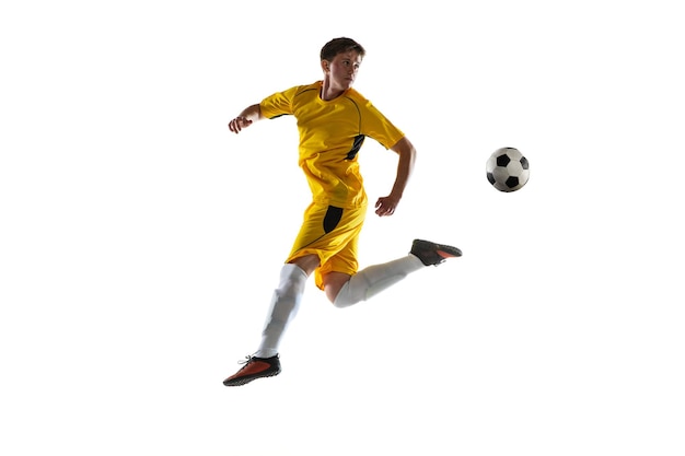 Photo young man male soccer football player training isolated on white background