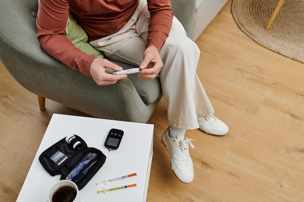 Young man managing diabetes through daily routines in a modern apartment