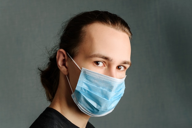 A young man in a medical mask