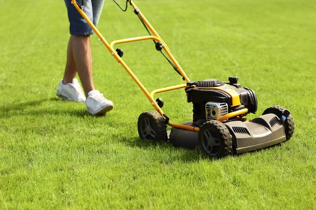 a young man mowing the lawn