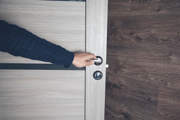 Young man opening room door