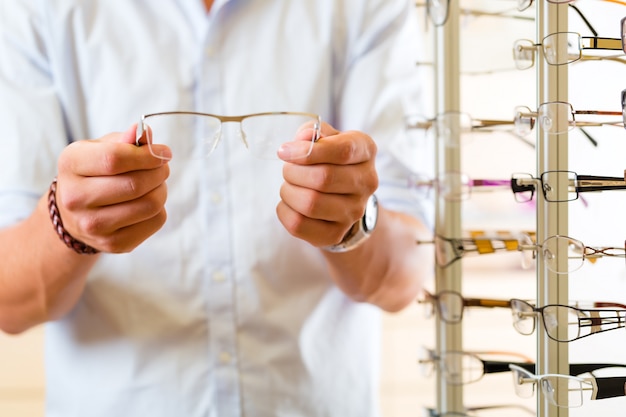 Young man at optician with glasses