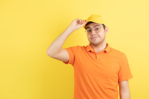 young man in orange uniform standing and posing. 