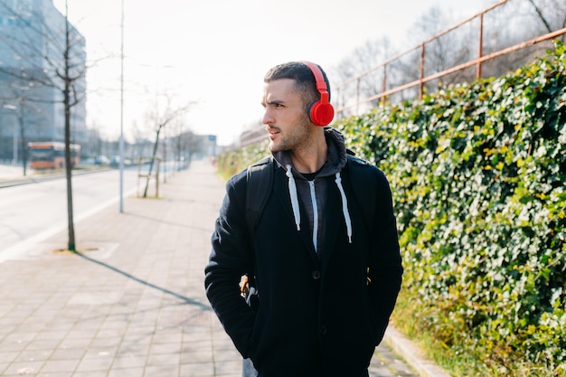 Young man outdoor listening music