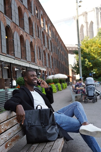 Young man outdoors exploring the city and using smartphone